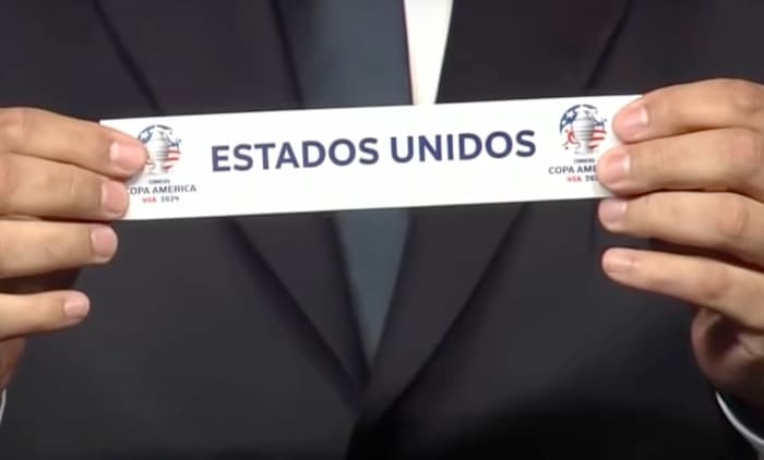 A close-up of a piece of paper featuring the name 'Estados Unidos' during the draw ceremony for the 2024 Copa America tournament