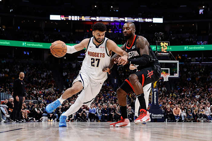 Nuggets guard Jamal Murray controls the ball as Houston Rockets forward Jeff Green (32) guards in the fourth quarter at Ball Arena.