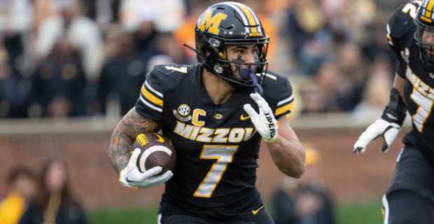 Missouri Tigers running back Cody Schrader on a rushing attempt during a college football game in the SEC.