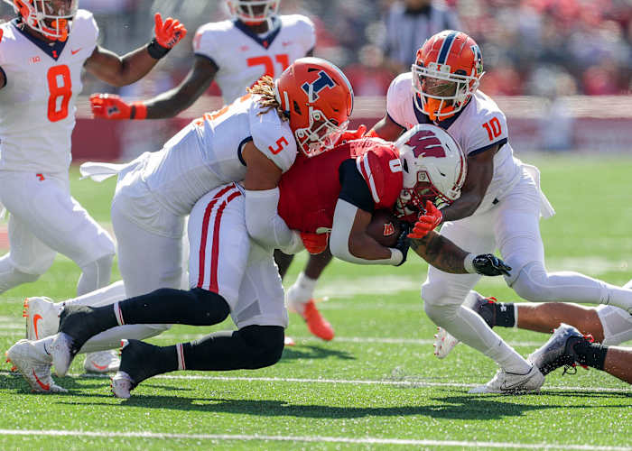 Illinois linebacker Calvin Hart Jr. (5) and defensive back Tahveon Nicholson (10) tackle Wisconsin running back Braelon Allen (0) on Saturday, October 1, 2022, at Camp Randall Stadium in Madison, Wis. Tork Mason/USA TODAY NETWORK-Wisconsin