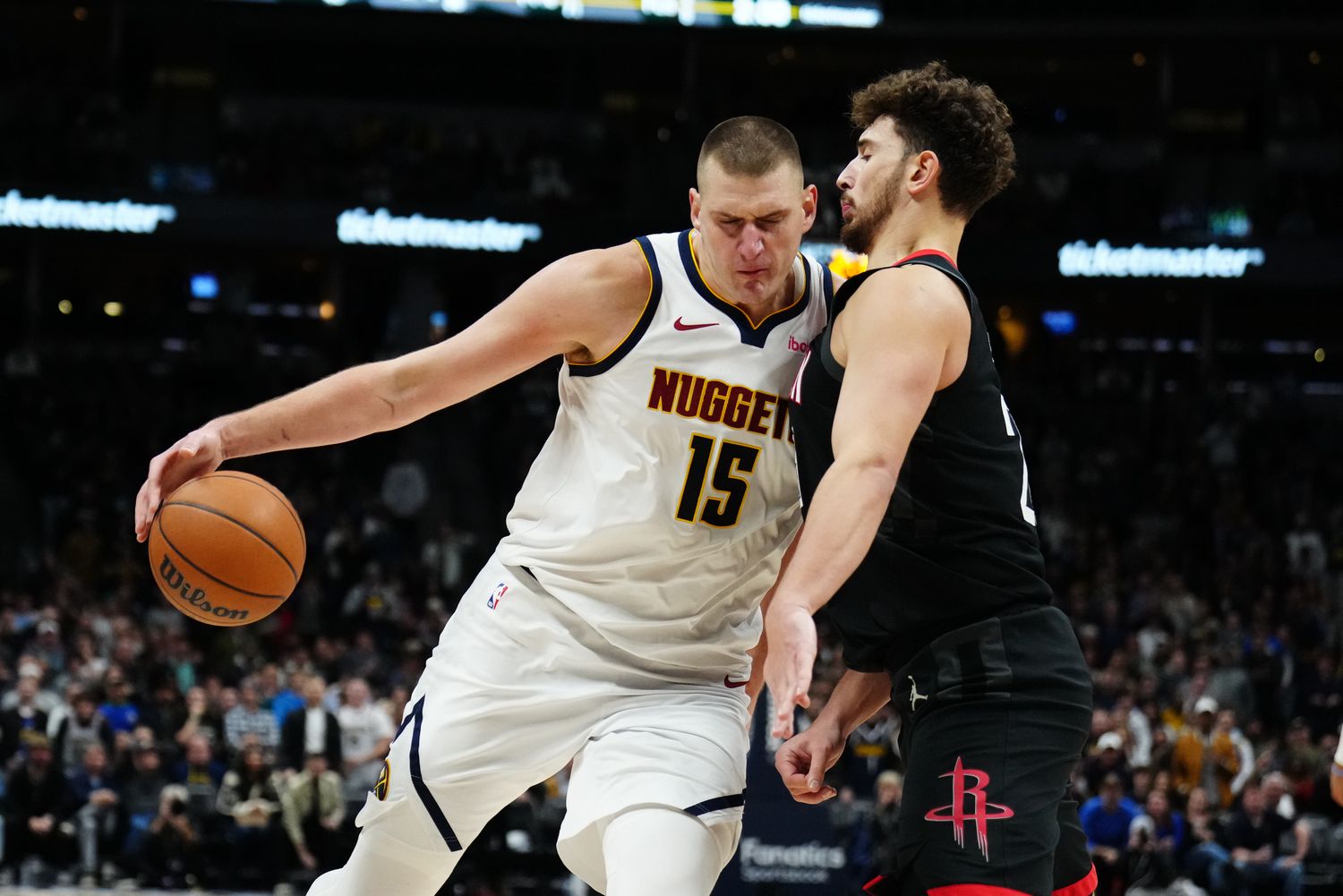 Nuggets center Nikola Jokic (15) drives at Houston Rockets center Alperen Sengun (28) in the second half at Ball Arena.