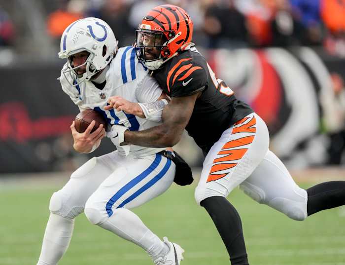 Dec 10, 2023; Cincinnati, Ohio, USA; Cincinnati Bengals linebacker Germaine Pratt (57) works to bring down Indianapolis Colts quarterback Gardner Minshew II (10) at Paycor Stadium. Mandatory Credit: Bob Scheer-USA TODAY Sports