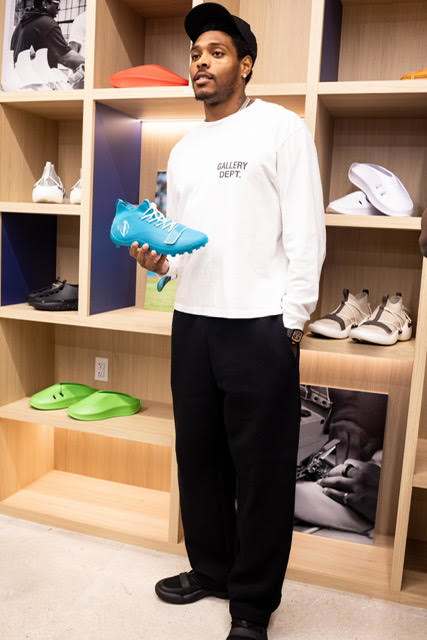 Jalen Ramsey holds his cleats in a sneakers store.