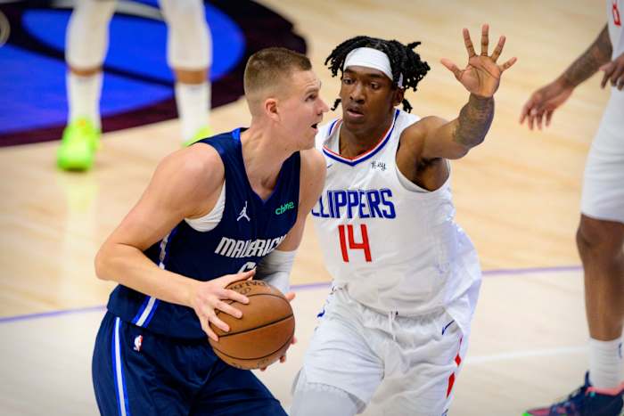 Mavs’ Kristaps Porzingis goes up for a shot against Clippers’ Terance Mann.