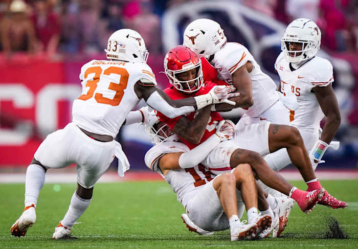 The Texas defense bring down Houston wide receiver Matthew Golden (2) in the fourth quarter of the Longhorn's game against the Houston Cougars at TDECU Stadium in Houston, Saturday, Oct. 21, 2023. Texas won the game 31-24.