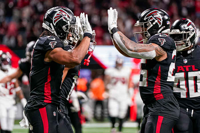 Atlanta Falcons running back Bijan Robinson (7) reacts with running back Tyler Allgeier (25) after running for a touchdown against the Tampa Bay Buccaneers during the second half at Mercedes-Benz Stadium.