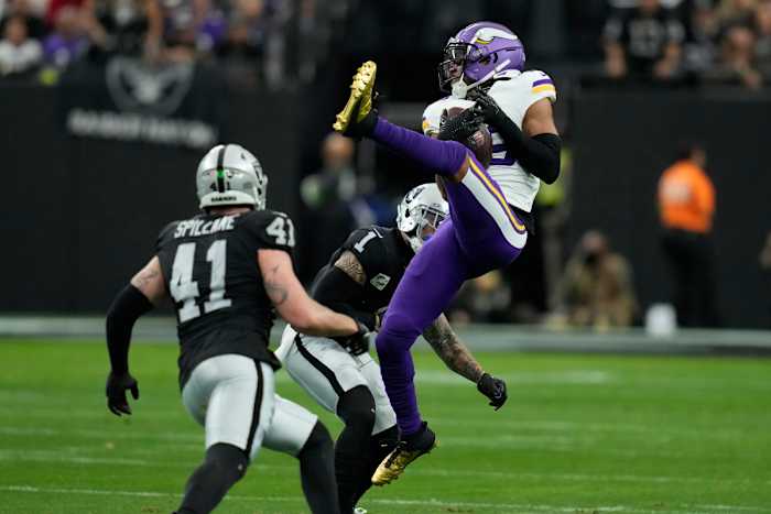 Minnesota Vikings wide receiver Justin Jefferson makes a catch as Las Vegas Raiders safety Marcus Epps (1) defends during the first half in Las Vegas. (AP Photo/John Locher)
