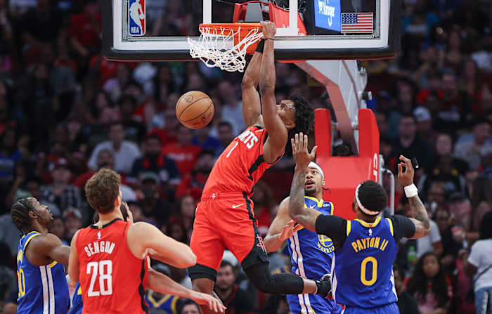 Rockets forward Amen Thompson dunks the ball as Golden State Warriors guard Moses Moody defends during the first quarter at Toyota Center.
