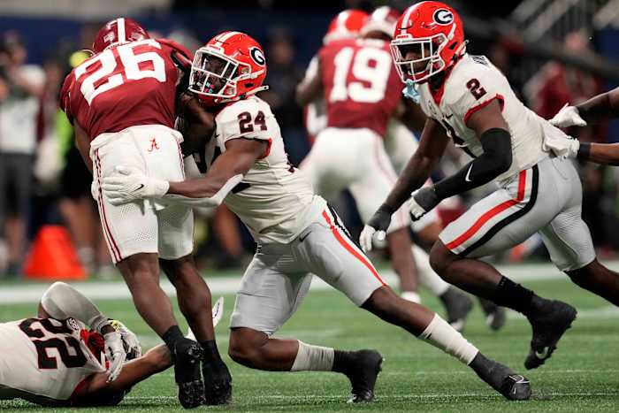 Dec 2, 2023; Atlanta, GA, USA; Georgia Bulldogs defensive back Malaki Starks (24) makes a tackle on Alabama Crimson Tide running back Jam Miller (26) during the second half in the SEC Championship game at Mercedes-Benz Stadium. (Dale Zanine / USA TODAY Sports).