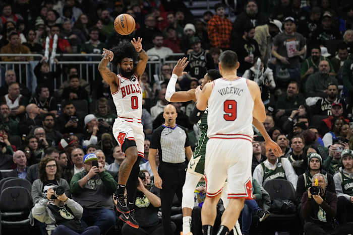 Chicago Bulls guard Coby White (0) passes the ball to center Nikola Vucevic (9) during the third quarter against the Milwaukee Bucks at Fiserv Forum.