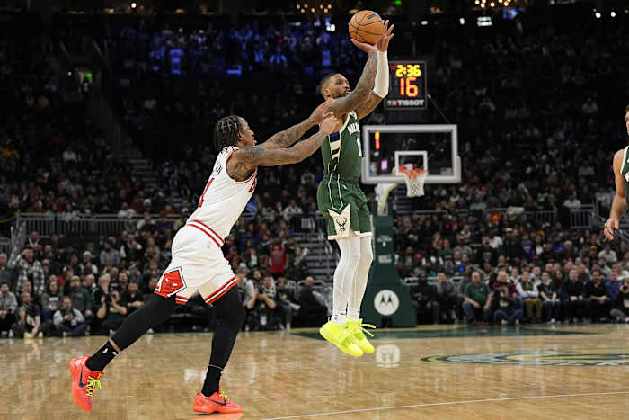 Chicago Bulls guard Coby White (0) shoots behind Chicago Bulls forward DeMar DeRozan (11)