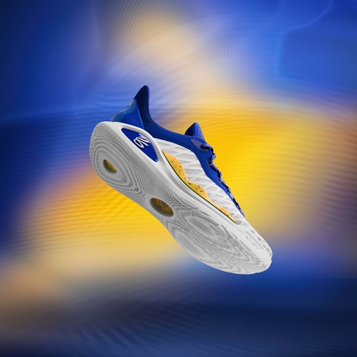 Side view of Stephen Curry's white, blue, and gold sneakers.