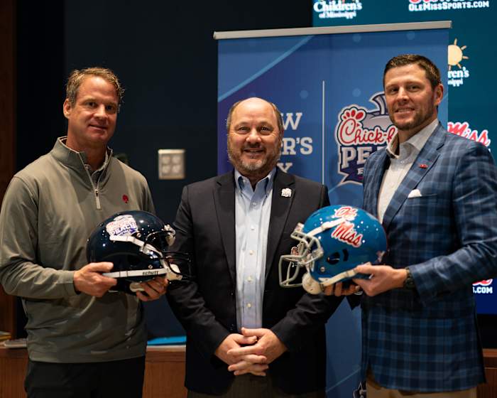 Ole Miss head coach Lane Kiffin (left), athletic director Keith Carter (right) and Peach Bowl CEO and president Gary Stokan.