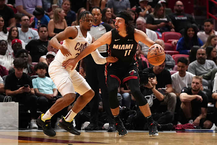 Dec 8, 2023; Miami, Florida, USA; Miami Heat guard Jaime Jaquez Jr. (11) dribbles the ball around Cleveland Cavaliers forward Isaac Okoro (35) during the second half at Kaseya Center.