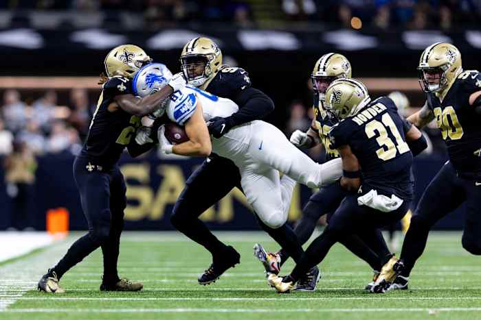 Dec 3, 2023; Detroit Lions tight end Sam LaPorta (87) is tackled by New Orleans Saints safety Jordan Howden (31), defensive tackle Bryan Bresee (90), and safety Tyrann Mathieu (32). Mandatory Credit: Stephen Lew-USA TODAY