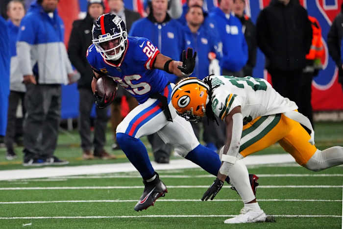 Dec 11, 2023; New York Giants running back Saquon Barkley (26) runs the ball past Green Bay Packers safety Darnell Savage (26). Mandatory Credit: Robert Deutsch-USA TODAY Sports