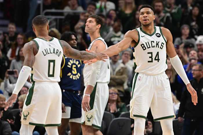 Milwaukee Bucks forward Giannis Antetokounmpo (34) celebrates with Milwaukee Bucks guard Damian Lillard (0) 