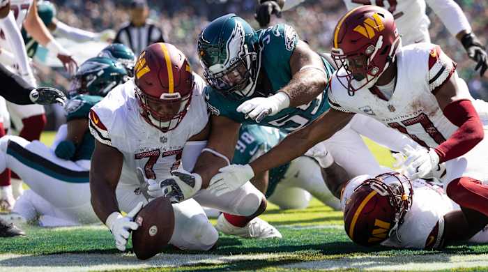 Commanders offensive tackle Saahdiq Charles and wide receiver Terry McLaurin recover a fumble in the end zone past Philadelphia Eagles defensive end Brandon Graham (55) for a touchdown