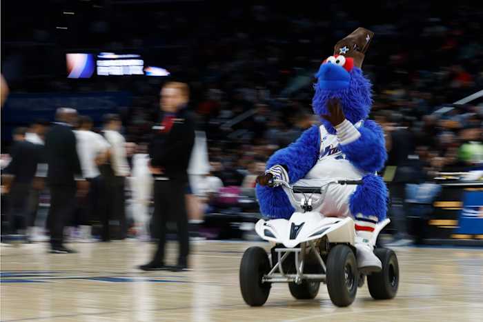 Washington Wizards mascot G-Wiz drives a motorized scooter around the court during a timeout against the Miami Heat in the third quarter at Capital One Arena