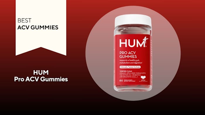 Clear bottle with red label that says "HUM Pro ACV Gummies" in white writing, against a red background