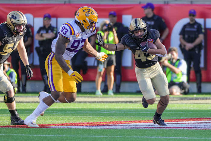 Jan 2, 2023; Orlando, FL, USA; Purdue Boilermakers running back Devin Mockobee (45) carries the ball against LSU Tigers defensive end Quency Wiggins (93) during the second half at Camping World Stadium
