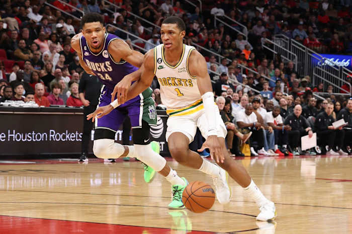 Houston Rockets forward Jabari Smith Jr. drives past Milwaukee Bucks forward Giannis Antetokounmpo