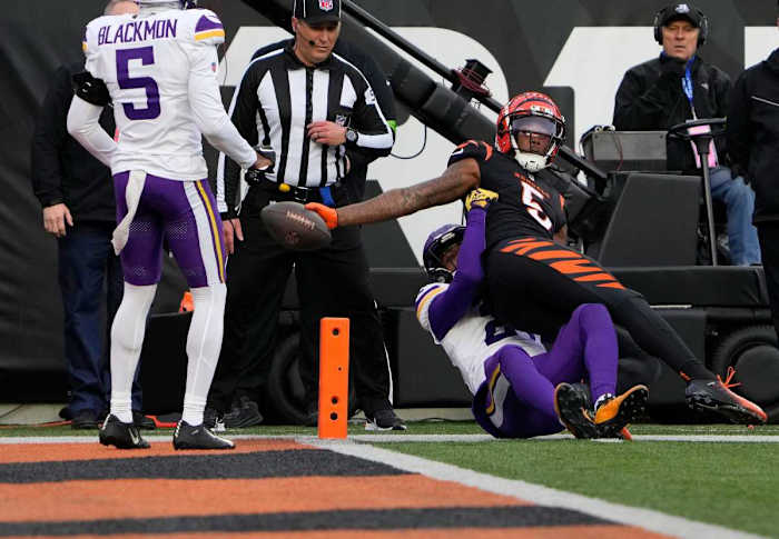 Cincinnati Bengals wide receiver Tee Higgins (5) makes a touchdown over Minnesota Vikings cornerback Akayleb Evans (21) in the 4th quarter Paycor Stadium Saturday, December 16, 2023.