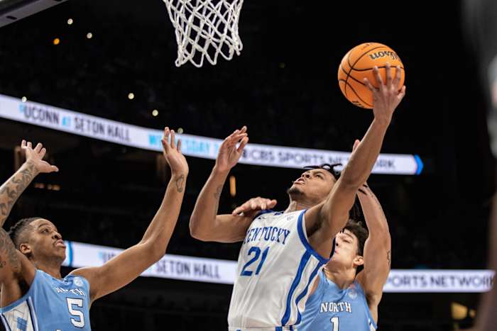 Dec 16, 2023; Atlanta, Georgia, USA; Kentucky Wildcats guard D.J. Wagner (21) attempts layup shot against North Carolina Tar Heels forward Armando Bacot (5) and North Carolina Tar Heels forward Zayden High (1) during the first half at State Farm Arena. Mandatory Credit: Jordan Godfree-USA TODAY Sports