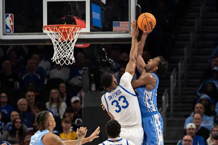 Dec 16, 2023; Atlanta, Georgia, USA; Kentucky Wildcats forward Ugonna Onyenso (33) blocks shot by North Carolina Tar Heels forward Harrison Ingram (55) during the first half at State Farm Arena. Mandatory Credit: Jordan Godfree-USA TODAY Sports