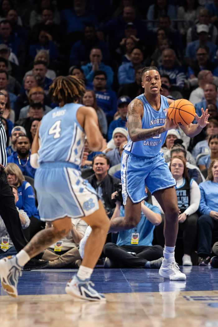 Dec 16, 2023; Atlanta, Georgia, USA; North Carolina Tar Heels forward Armando Bacot (5) passes the ball to North Carolina Tar Heels guard RJ Davis (4) in game against Kentucky Wildcats during the first half at State Farm Arena. Mandatory Credit: Jordan Godfree-USA TODAY Sports