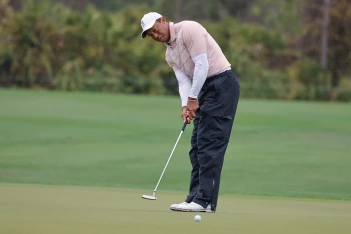 Tiger Woods putts on the fifth green during the PNC Championship.