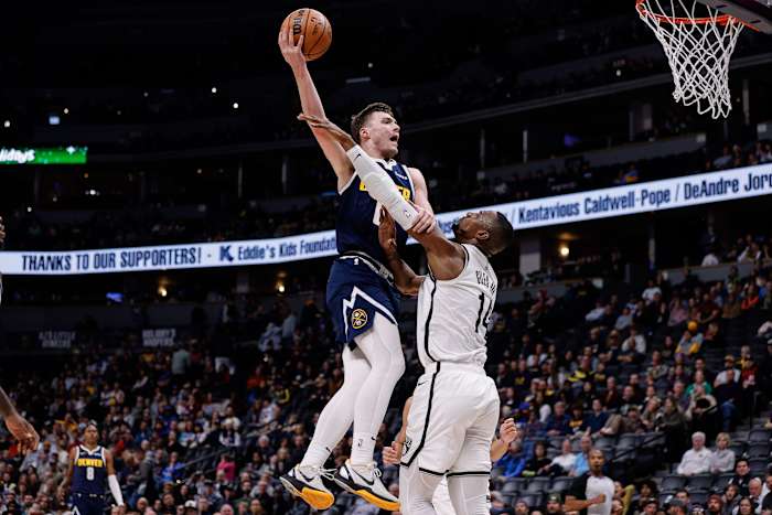 Denver Nuggets guard Christian Braun (0) drives to the net against Brooklyn Nets forward Harry Giles III (14)