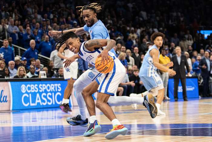 Dec 16, 2023; Atlanta, Georgia, USA; Kentucky Wildcats guard Rob Dillingham (0) dribbles the ball against North Carolina Tar Heels forward Jae'Lyn Withers (24) during the second half at State Farm Arena. Mandatory Credit: Jordan Godfree-USA TODAY Sports