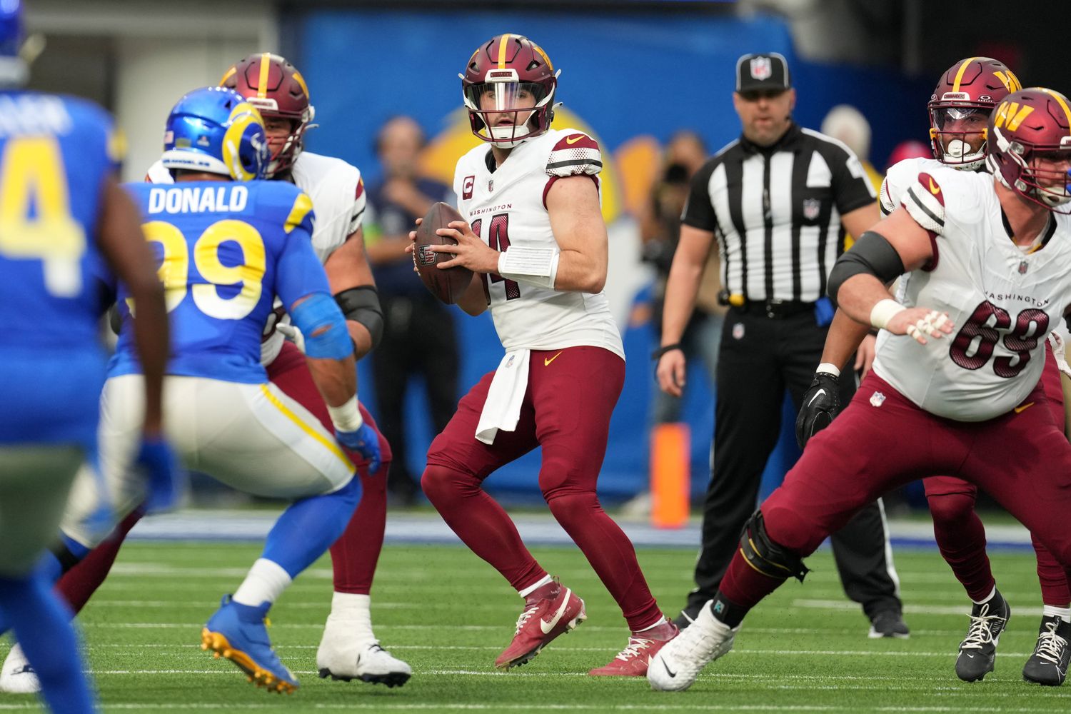 Washington Commanders quarterback Sam Howell (14) throws the ball against the Los Angeles Rams in the first half at SoFi Stadium.
