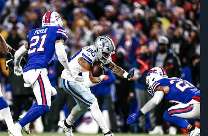 Cowboys running back Tony Pollard fights through Bills defenders during Sunday's game.