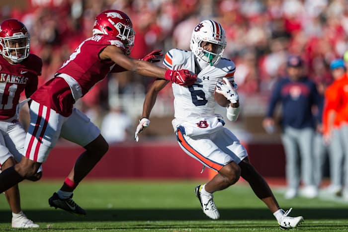 Nov 11, 2023; Fayetteville, Arkansas, USA; Auburn Tigers wide receiver Ja'Varrius Johnson (6) tries to escape the grasp of Arkansas Razorbacks defensive back Jayden Johnson (8) during the first quarter at Donald W. Reynolds Razorback Stadium. Mandatory Credit: Brett Rojo-USA TODAY Sports