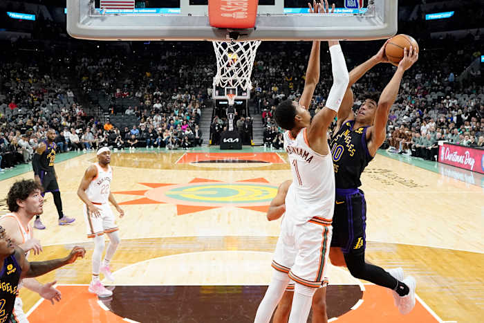 Dec 15, 2023; San Antonio, Texas, USA; Los Angeles Lakers guard Max Christie (10) shoots over San Antonio Spurs forward Victor Wembanyama (1) during the first half at Frost Bank Center.