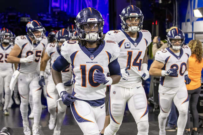 Denver Broncos wide receiver Jerry Jeudy (10) leads his team out for warm ups before the game against the Detroit Lions at Ford Field.