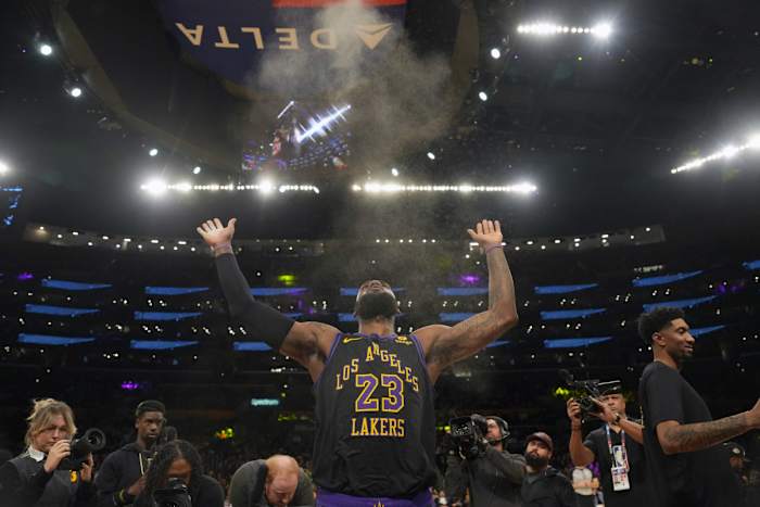 Los Angeles Lakers forward LeBron James throws chalk into the air before his team’s game against the New York Knicks at Crypto.com Arena.