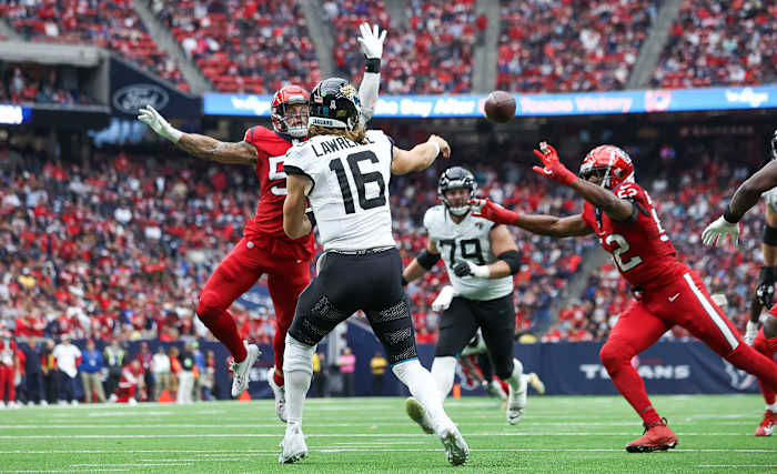 Jaguars quarterback Trevor Lawrence (16) attempts a pass as Houston Texans linebacker Blake Cashman (53) during the third quarter at NRG Stadium.