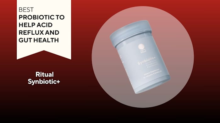 Blue pill bottle with white writing that says "Synbiotic+" against a red background