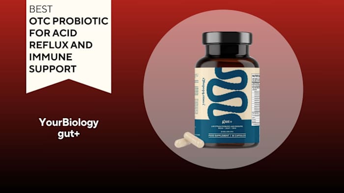 Brown pill bottle with a yellow and blue label that says "gut+" next to two yellow pills