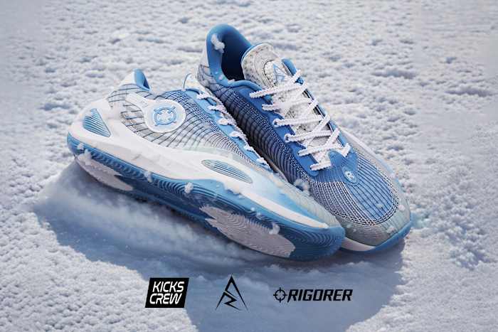 Side view of Austin Reaves' white and blue Rigorer sneakers.