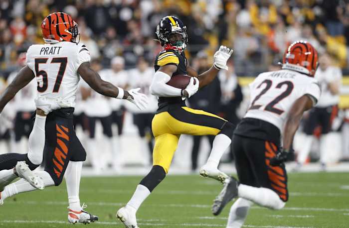 Dec 23, 2023; Pittsburgh, Pennsylvania, USA; Pittsburgh Steelers wide receiver George Pickens (14) runs on an eight-six yard touchdown reception as Cincinnati Bengals linebacker Germaine Pratt (57) and cornerback Chidobe Awuzie (22) chase during the first quarter at Acrisure Stadium. Mandatory Credit: Charles LeClaire-USA TODAY Sports