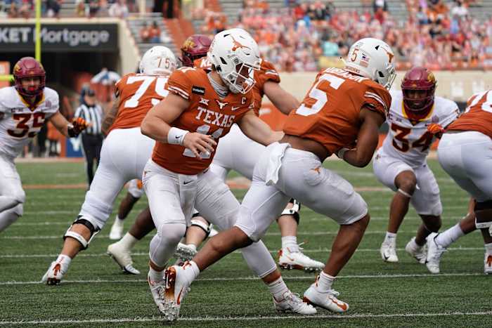 Nov 27, 2020; Austin, Texas, USA; Texas Longhorns quarterback Sam Ehlinger (11) hands the ball off to running back Bijan Robinson (5) in the first quarter against the Iowa State Cyclones at Darrell K Royal-Texas Memorial Stadium. Mandatory Credit: Scott Wachter-USA TODAY Sports