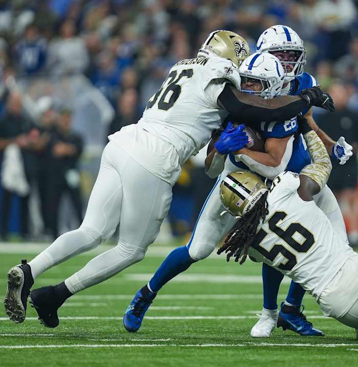 New Orleans Saints defensive end Carl Granderson (96) and linebacker Demario Davis (56) tackle Indianapolis Colts running back Jonathan Taylor (28). © Jenna Watson/IndyStar / USA TODAY NETWORK