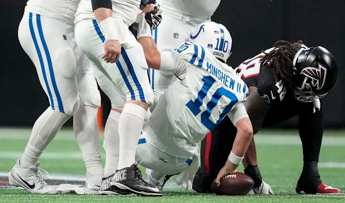 Indianapolis Colts quarterback Gardner Minshew II (10) is helped up from the turf after a sack by Sunday, Dec. 24, 2023, during a game against the Atlanta Falcons at Mercedes-Benz Stadium in Atlanta.  