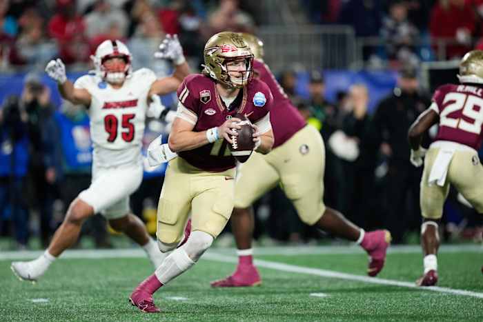 Dec 2, 2023; Charlotte, NC, USA; Florida State Seminoles quarterback Brock Glenn (11) scrambles with the ball against the Louisville Cardinals during the third quarter at Bank of America Stadium. (Jim Dedmon / USA TODAY Sports).