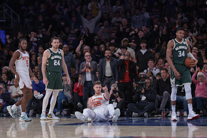 New York Knicks center Isaiah Hartenstein (55) reacts after a basket as Milwaukee Bucks guard Pat Connaughton (24) and forward Giannis Antetokounmpo (34) look up