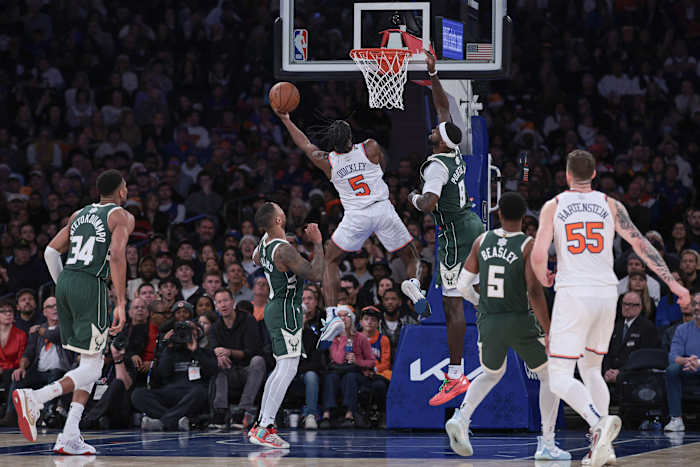 New York Knicks guard Immanuel Quickley (5) drives to the basket as Milwaukee Bucks forward Bobby Portis (9) and guard Damian Lillard (0) 